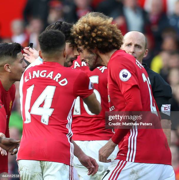 Marouane Fellaini of Manchester United clashes with Claudio Yacob of West Bromwich Albion during the Premier League match between Manchester United...