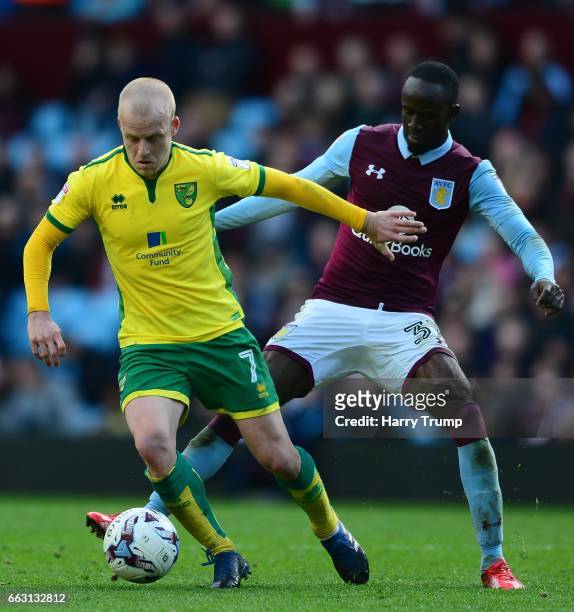 Steven Naismith of Norwich City is tackled by Albert Adomah of Aston Villa during the Sky Bet Championship match between Aston Villa and Norwich City...