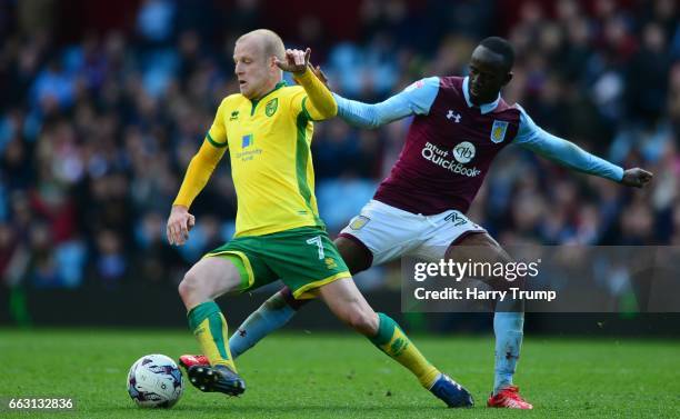 Steven Naismith of Norwich City is tackled by Albert Adomah of Aston Villa during the Sky Bet Championship match between Aston Villa and Norwich City...