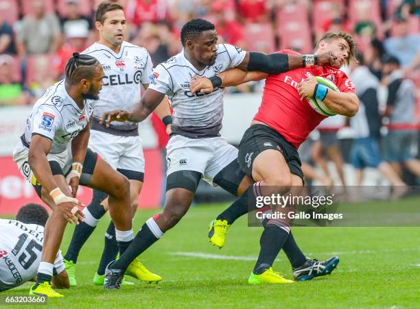 Rohan Jansen Van Rensburg of the Lions tackled by Lwazi Mvovo of the Sharks during the Super Rugby match between Emirates Lions and Cell C Sharks at...