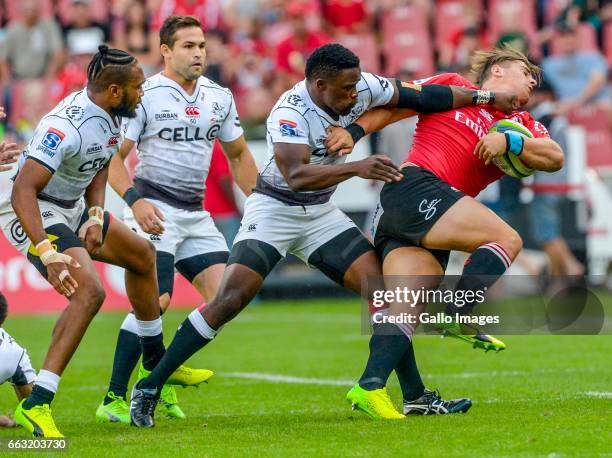 Rohan Jansen Van Rensburg of the Lions tackled by Lwazi Mvovo of the Sharks during the Super Rugby match between Emirates Lions and Cell C Sharks at...