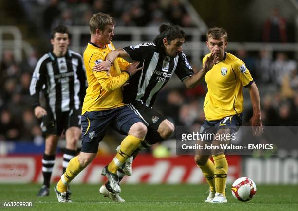 Newcastle United's Jonas Gutierrez battles for the ball with West Bromwich Albion's Chris Brunt .
