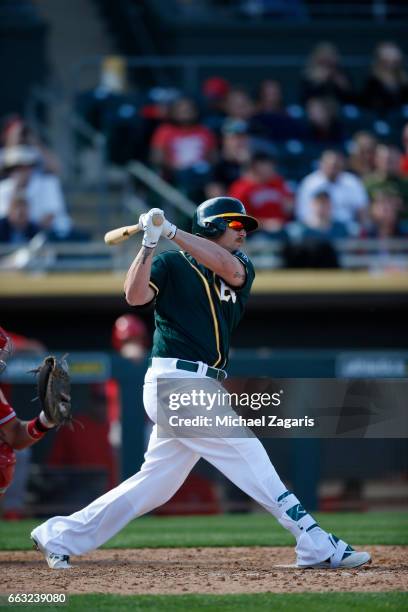 Chris Parmelee of the Oakland Athletics bats during the game against the Los Angeles Angels of Anaheim at Hohokam Stadium on February 26, 2017 in...