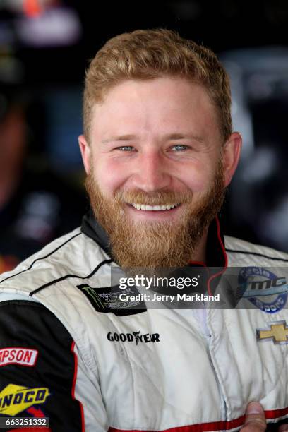 Jeffrey Earnhardt, driver of the Little Joes Autos/Curtis Key Plumbing Chevrolet, looks on from the garage during practice for the Monster Energy...