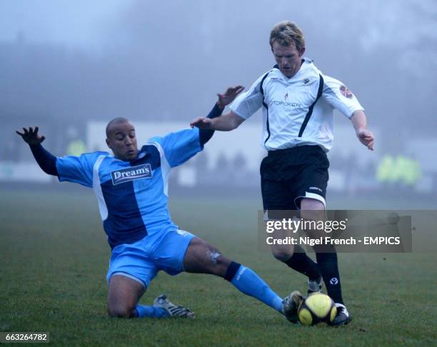 Eastwood Town's Andy Todd is tackled by Wycombe Wanderers' Leon Johnson.