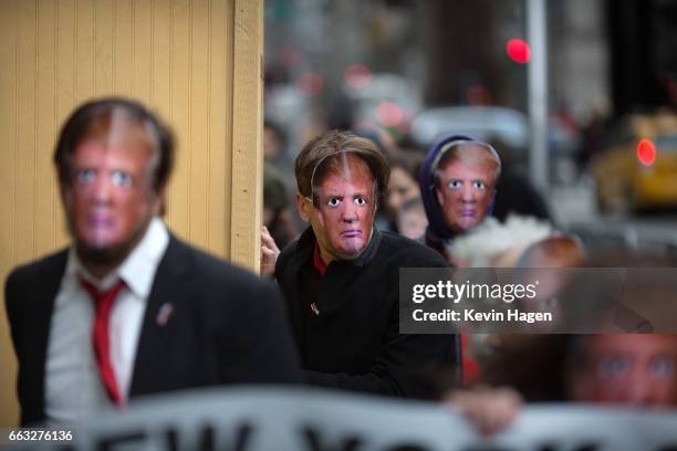 Participants wear President Trump masks as part of the event entitled: "New York City's 32nd Annual April Fools' Day Parade: It's a Trumpathon!" on...