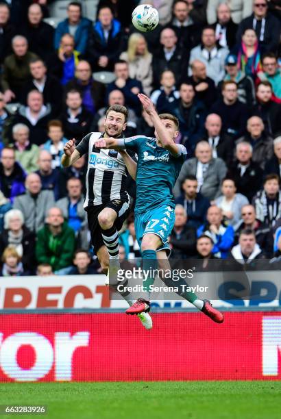 Paul Dummett of Newcastle United challenges Ryan Colclough of Wigan Athletic for a header during the Sky Bet Championship match between Newcastle...