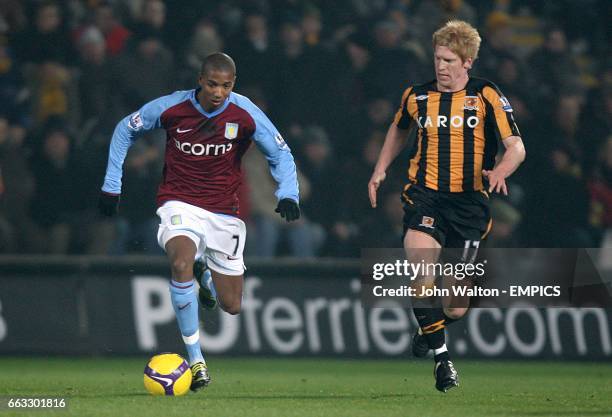 Aston Villa's Ashley Young and Hull City's Paul McShane battle for the ball