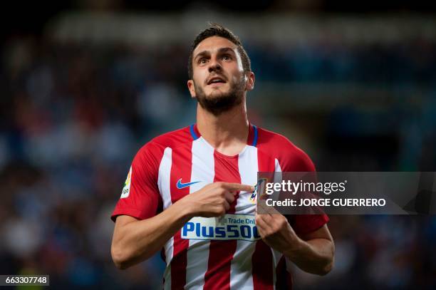 Atletico Madrid's midfielder Koke celebrates after scoring during the Spanish league football match Malaga CF vs Club Atletico de Madrid at La...