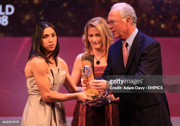 Brazil's Marta accepts her FIFA Womens World Player of the Year award from German legend Franz Beckenbauer