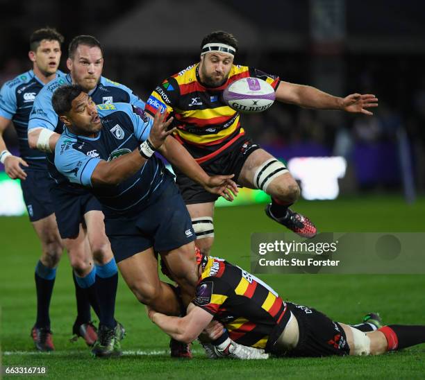 Blues number 8 Nick Williams offloads despite the tackle of Tom Savage during the European Rugby Challenge Cup match between Gloucester Rugby and...