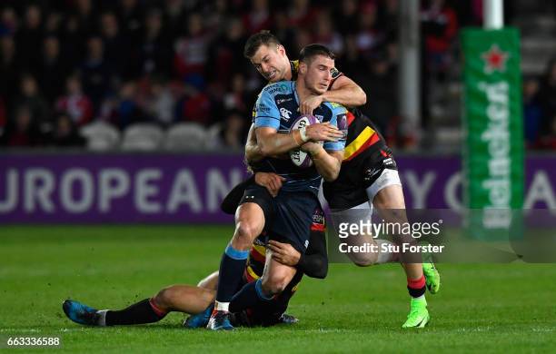 Blues centre Steven Shingler is tackled by Billy Twelvetrees and Henry Trinder of Gloucester during the European Rugby Challenge Cup match between...