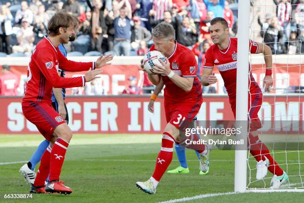 Bastian Schweinsteiger of Chicago Fire celebrates by kissing the ball after scoring a goal in the first half against the Montreal Impact during an...