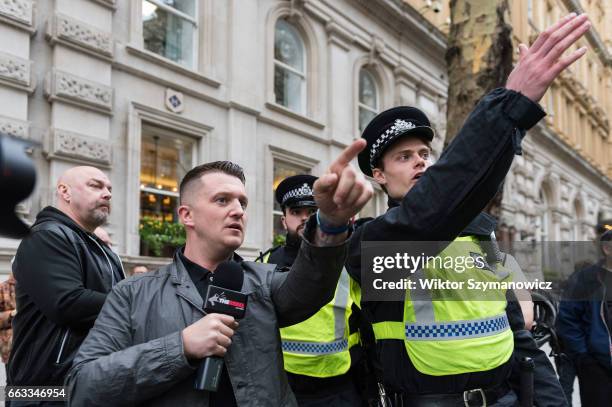 Tommy Robinson, former leader of the English Defence League is escorted by the police as supporters of far-right and anti-Islamic English Defence...