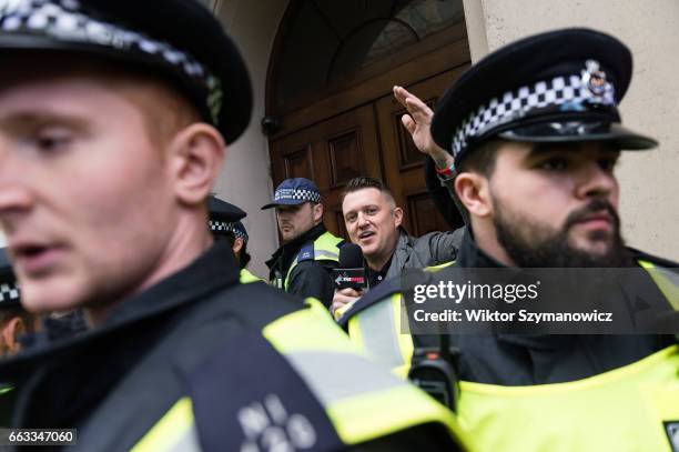 Tommy Robinson, former leader of the English Defence League is escorted by the police as supporters of far-right and anti-Islamic English Defence...