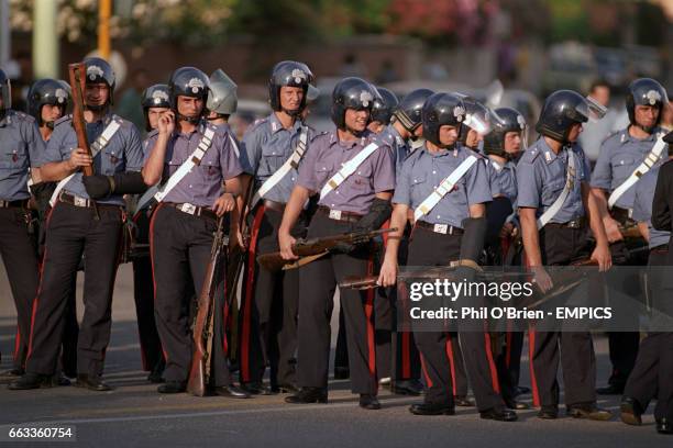 Italian riot police with their rifles keep an eye on the England fans before the match