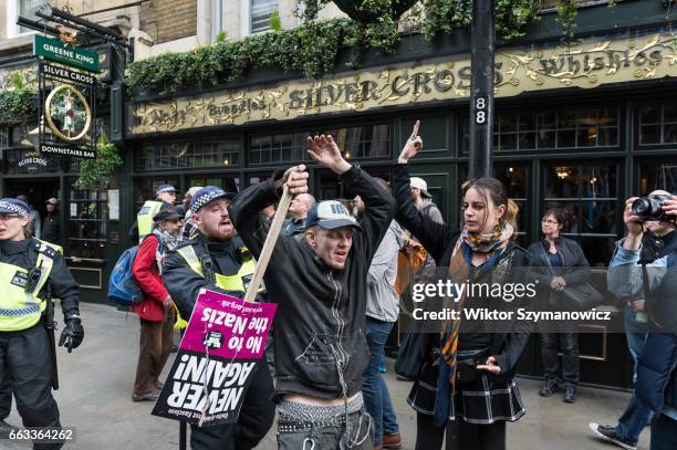 Police officer clashes with members of anti-fascist groups, Unite Against Fascism and Antifaschistische Aktion during a counter-demonstration to...