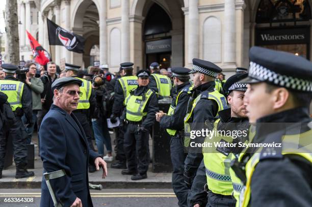Supporter of anti-fascist groups, Unite Against Fascism and Antifaschistische Aktion confronts police cordon during a counter-demonstration to oppose...