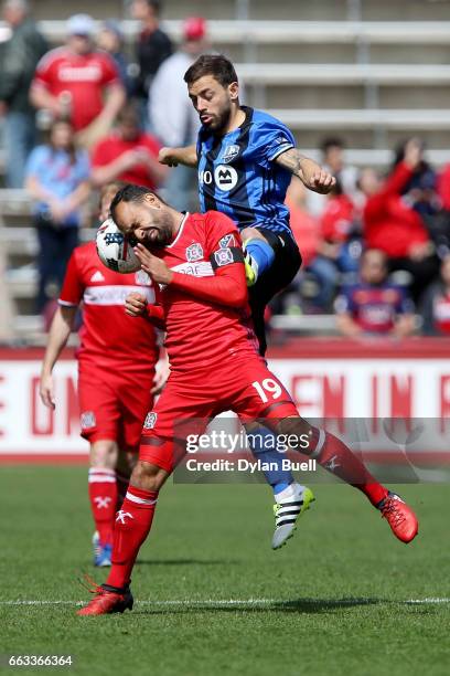 Juninho of Chicago Fire and Hernan Bernardello of Montreal Impact battle for the ball in the first half during an MLS match at Toyota Park on April...
