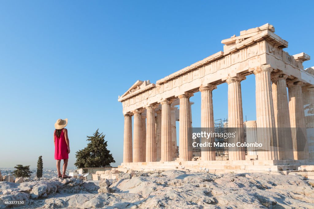 Woman in front of Parthenon temple on the Acropolis, Athens, Greece