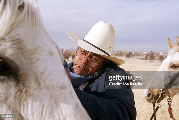 Modern day cowboy talks on his cell phone during a cattle drive January 22, 2000 in El Paso, Texas. The cattle drive is part of the Southwestern...
