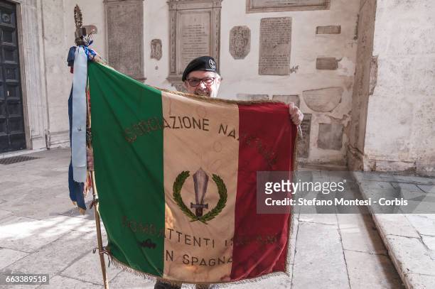 Member of the National Association of Combatants Italians in Spain displays an Italian national flag as they celebrate the 78th Anniversary of the...