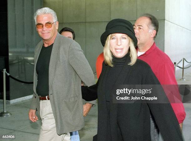 Barbra Streisand walks with husband James Brolin to a demonstration where she spoke against the impeachment of President Bill Clinton December 16,...