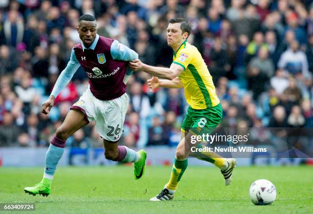 Jonathan Kodjia of Aston Villa is challenged by Jonny Howson of Norwich City during the Sky Bet Championship match between Aston Villa and Norwich...