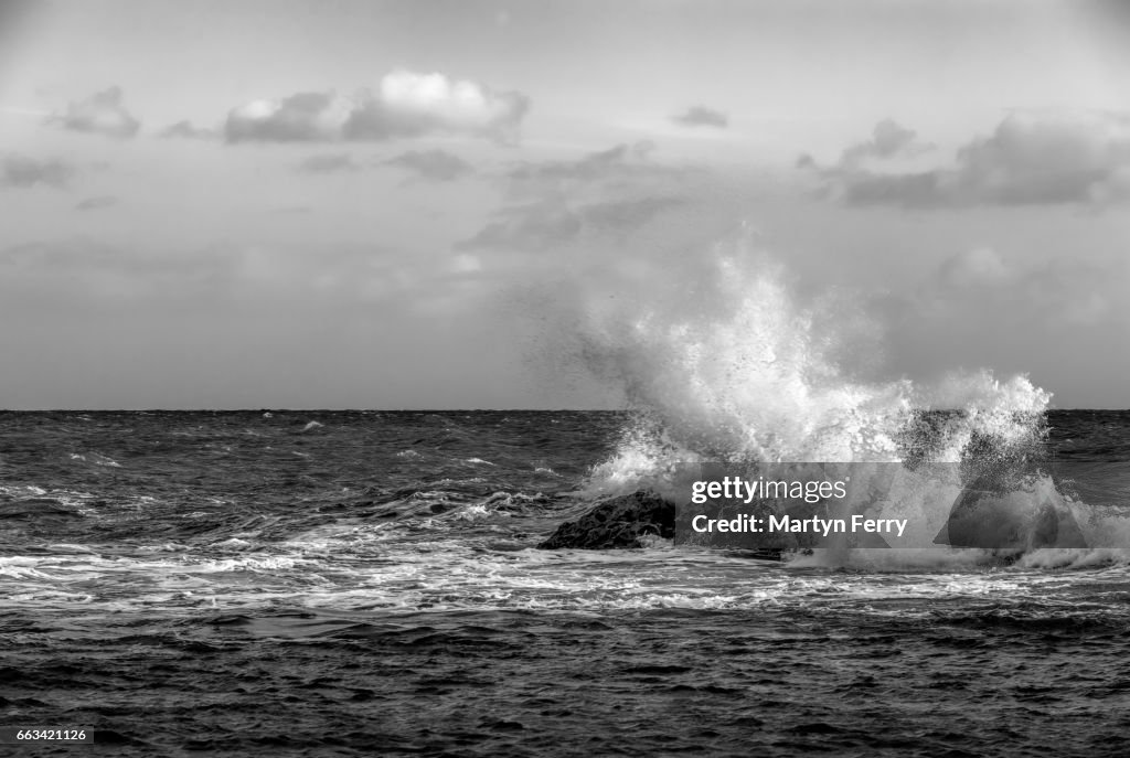 Crashing monochrome wave, Man O'War Bay, Lulworth, Isle of Purbeck, Dorset, UK