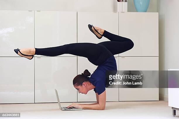 contortionist using laptop computer - büro sport stock pictures, royalty-free photos & images