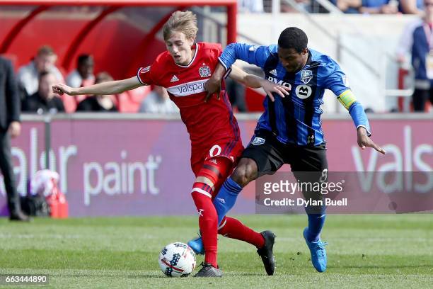 Patrice Bernier of Montreal Impact fouls Daniel Johnson of Chicago Fire in the second half during an MLS match at Toyota Park on April 1, 2017 in...
