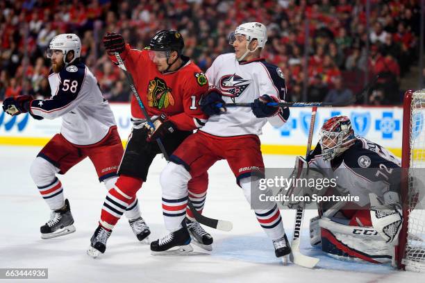 Chicago Blackhawks left wing Richard Panik battles with Columbus Blue Jackets defenseman David Savard , Columbus Blue Jackets defenseman Jack Johnson...