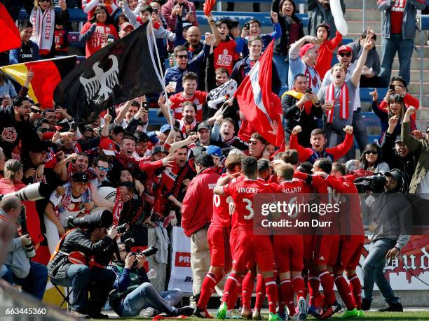 Bastian Schweinsteiger of Chicago Fire celebrates with teammates and fans after scoring a goal against the Montreal Impact during first half at...