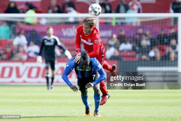 Joao Meira of Chicago Fire fouls Dominic Oduro of Montreal Impact in the second half during an MLS match at Toyota Park on April 1, 2017 in...