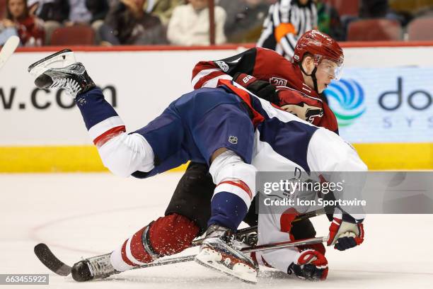 Arizona Coyotes defenseman Connor Murphy and Washington Capitals left wing Marcus Johansson get tangled up during the NHL hockey game between the...