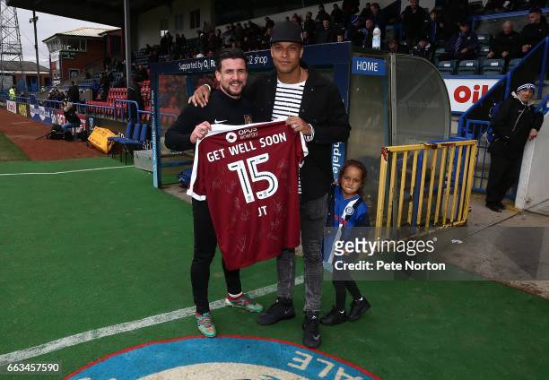 David Buchanan of Northampton Town presents a signed Northampton Town shirt to Joe Thompson of Rochdale as a show of solidarity with Thompson who has...