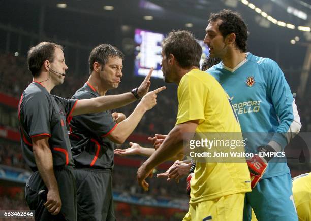 The linesman tells Villarreal's goalkeeper Diego Lopez to back off as referee Wolfgang Stark issue's Villarreal's Sebastian Eguren with a red card