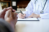 patient listening intently to a male doctor explaining patient symptoms or asking a question as they discuss paperwork together in a consultation

 Stock photo ID: 610816619

 S M L Size Guide
Large  |  4896 px x 3264 px  |  41.5cm x 27.6cm @ 300 dpi
   U