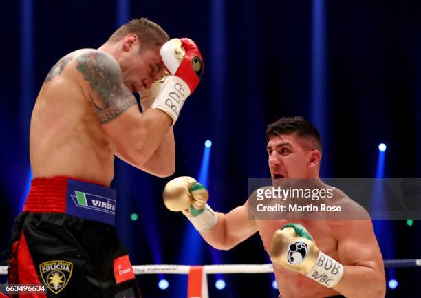 Marco Huck of Germany and Mairis Briedis of Latvia exchange punches during their WBC Cruiserweight World Championship title fight at Westfalenhalle...