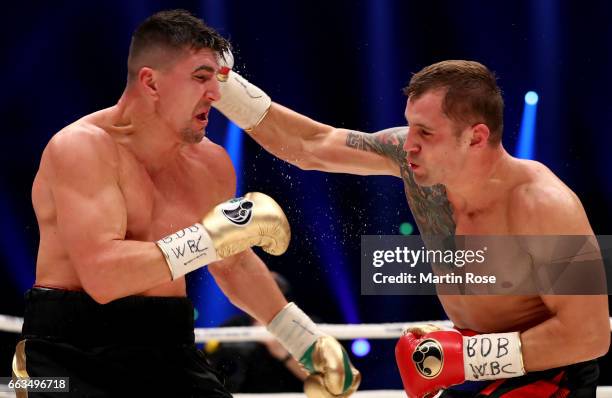 Marco Huck of Germany and Mairis Briedis of Latvia exchange punches during their WBC Cruiserweight World Championship title fight at Westfalenhalle...