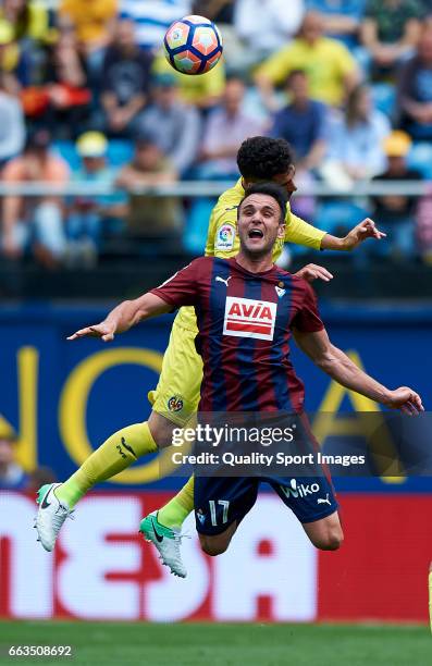 Alvaro Gonzalez of Villarreal competes for the ball with Kike Garcia of Eibar during the La Liga match between Villarreal CF and SD Eibar at Estadio...