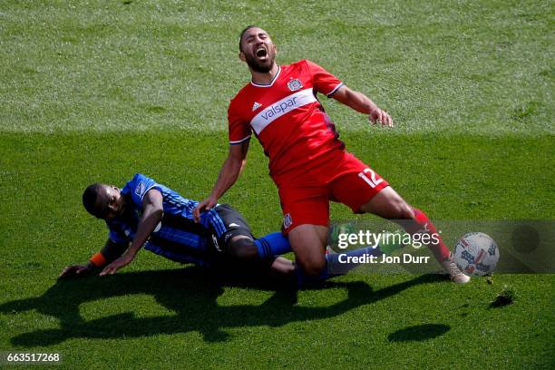 Chris Duvall of Montreal Impact fouls Arturo Alvarez of Chicago Fire and received a yellow card during the second half at Toyota Park on April 1,...