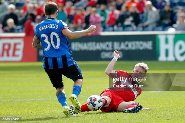 Bastian Schweinsteiger of Chicago Fire stoppage time against Hernan Bernardello of Montreal Impact during the second half at Toyota Park on April 1,...