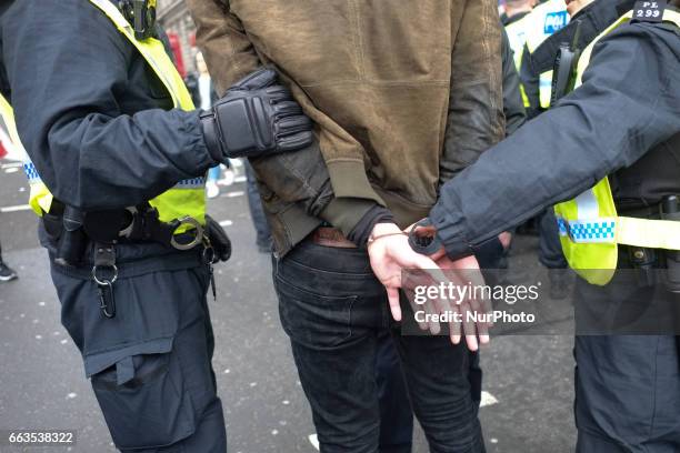 An activist from a counter demonstration organised by the Unite Against Fascism organisation against the marches by the far-right groups Britain...