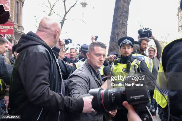Stephen Christopher Yaxley-Lennon, AKA Tommy Robinson, former leader of the right-wing EDL is escorted away by police from a Britain First march and...
