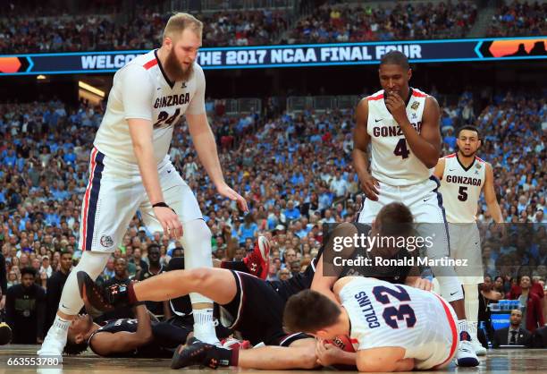 Maik Kotsar of the South Carolina Gamecocks and Zach Collins of the Gonzaga Bulldogs compete for a loose ball in the second half during the 2017 NCAA...