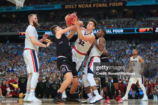 Zach Collins of the Gonzaga Bulldogs and Maik Kotsar of the South Carolina Gamecocks compete for a loose ball in the second half during the 2017 NCAA...