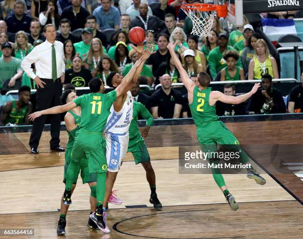 Tony Bradley of the North Carolina Tar Heels drives to the basket over Keith Smith and Casey Benson of the Oregon Ducks during the 2017 NCAA Photos...
