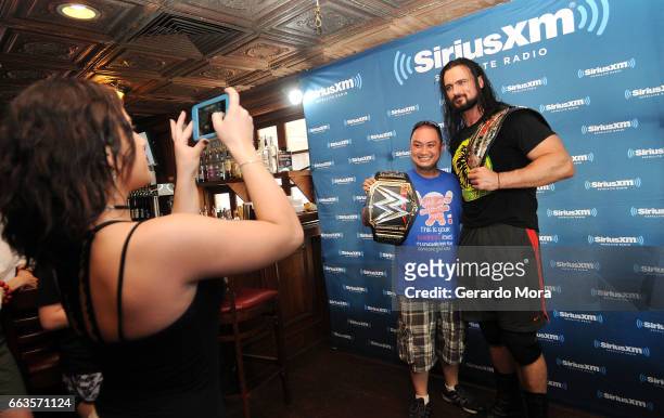 Wrestler Drew Galloway poses with a fan during the SiriusXM's Busted Open Live From WrestleMania 33on April 1, 2017 in Orlando City.