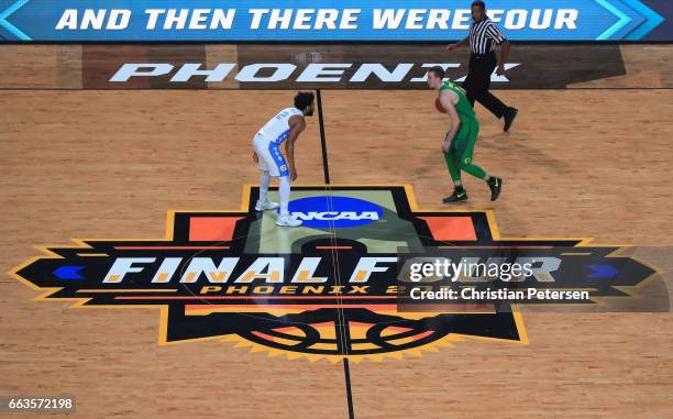 Casey Benson of the Oregon Ducks brings the ball up court against Joel Berry II of the North Carolina Tar Heels in the first half during the 2017...